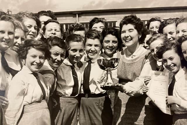 The girls school celebrating a trophy win.