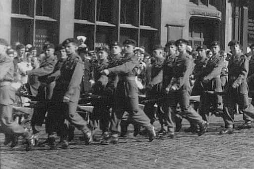 Durham Light Infantry soldiers march through Durham Market Square in the 1950s before heading off to join the United Nations forces in the Korea conflict.