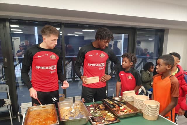 Dan Neil and Aji Alese dish out some Caribbean food to the youngsters. 