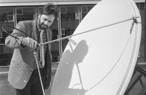 Teacher Jerry Fitzgibbon with the dish on the roof of the school.