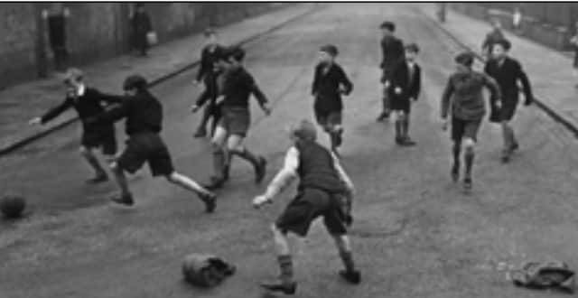 Jumpers for goalposts in this game of street football.
