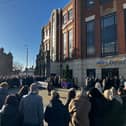 The remembrance ceremony outside of Hays Travel in Keel Square. 