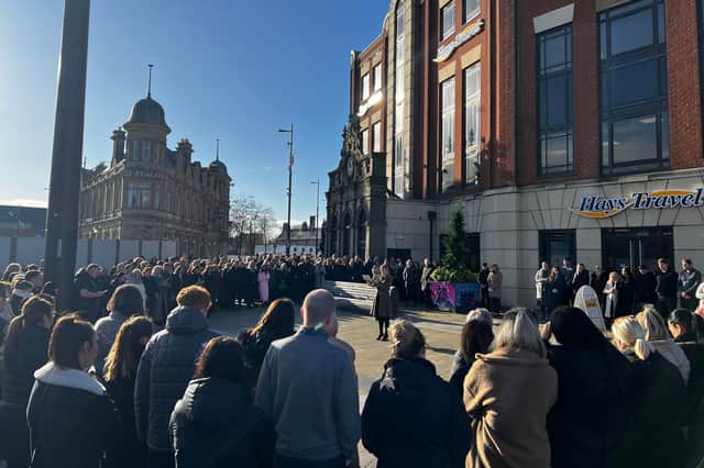 The remembrance ceremony outside of Hays Travel in Keel Square. 