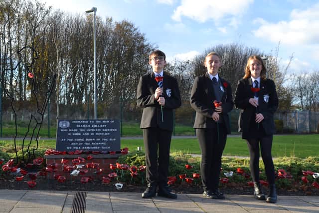 Pupils Lacey Smith, Anna Temple and Owen McGann with their clay poppies.