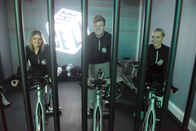 A spinning session taking place behind the cell bars.