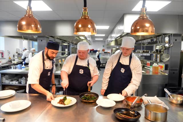 Head chef Geoff Rutherford, far left, with students in the kitchen