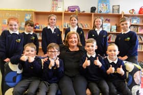 Thorney Close Primary School headteacher Catherine Jones and pupils celebrate their good Ofsted judgement. 