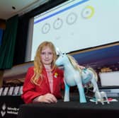 Francesca with a prototype of her winning unicorn design.
