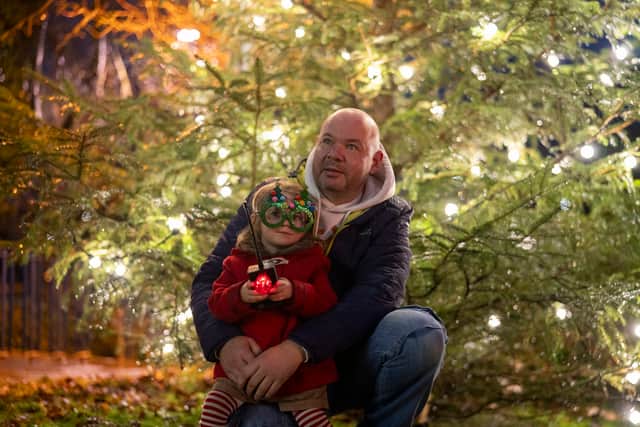 Dad and daughter enjoy the wonder of the Christmas lights.