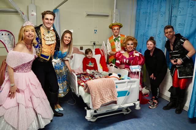 The cast were visiting children on the ward. 