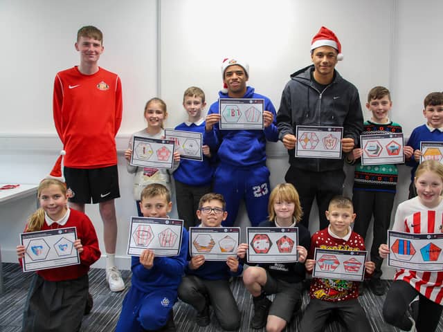 Jewison Bennette and Mason Burstow show off their football designs with children from St Mary's Catholic Primary School.