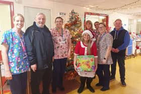 Emma Olsen, Tommy Goodey and Ray Knox, volunteers from the Grindon Young People's Centre, present gifts to staff from Sunderland Royal Hospital's paediatric wards. Submitted picture.