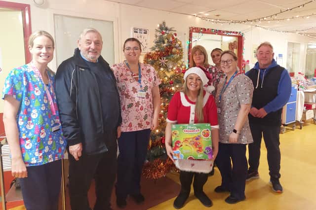 Emma Olsen, Tommy Goodey & Ray Knox, volunteers from the Grindon Young People's Centre, present gifts to staff from Sunderland Royal Hospital's paediatric wards. Submitted picture.