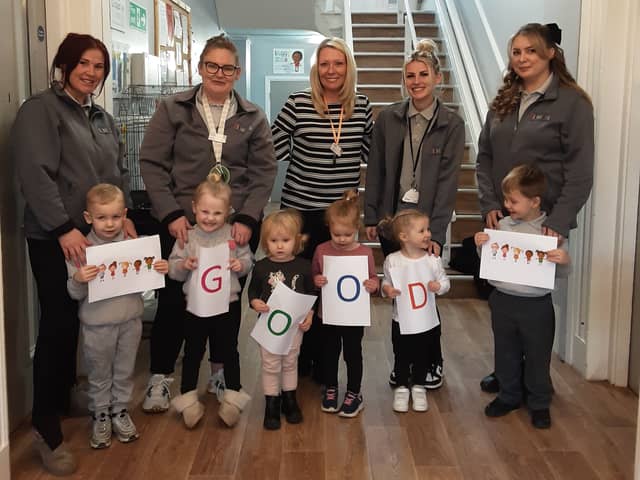 Your Co-op Little Pioneers Nursery & Pre-School manager Lisa Robertson celebrates the settings good Ofsted report with staff and children.