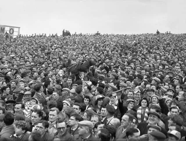 A spot of crowd surfing at the 1961 6th round FA Cup tie.