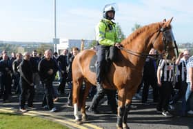 The police presence as Newcastle fans arrive for a previous derby match at the Stadium of Light.
