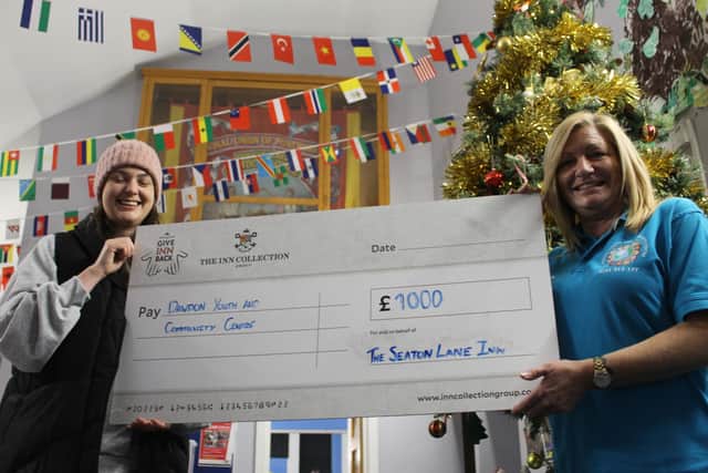 Ruth Blakey representing the Seaton Lane Inn, left, handing over the cheque to Marion McKenna of Dawdon Youth and Community Centre.