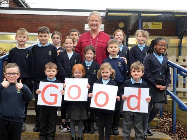 Pupils from St Joseph's Catholic Primary School celebrate their good Ofsted report with headteacher Elizabeth Maher.