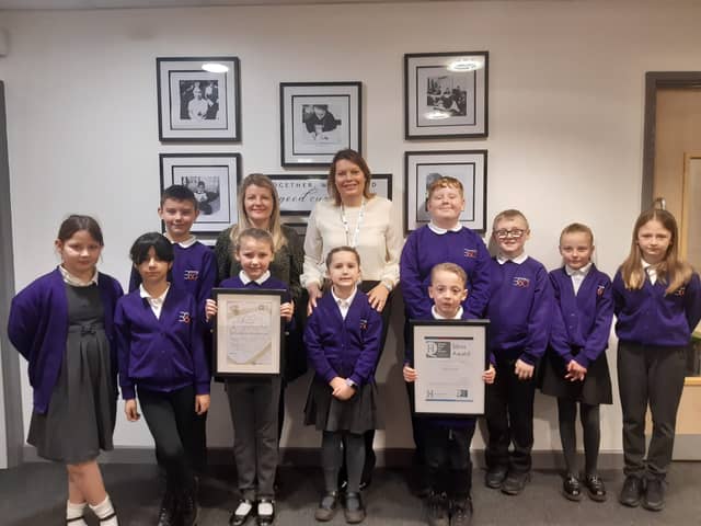 Headteacher Helena West and history lead Sarah Bolton celebrate the two awards with pupils.