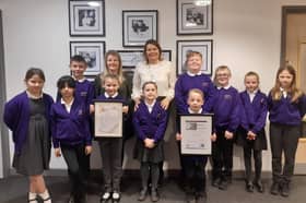 Headteacher Helena West and history lead Sarah Bolton celebrate the two awards with pupils.