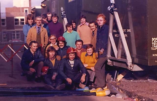 Ron Lawson, bottom centre, with fellow workers at the scene.
