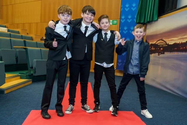 The boys pose on the red carpet before their movie premiere.
