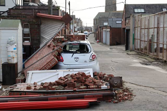 A car stands under a pile of bricks after a wall collapsed onto the vehicle overnight on Beverley Terrace in Cullercoats, North Tyneside, as Storm Jocelyn hits the UK hot on the heels of Storm Isha, with strong winds and heavy rain sparking further damage and disruption. NNP.