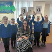 Head teacher Anna Young and children at Wessington Primary School celebrate their good Ofsted report.