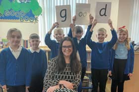 Head teacher Anna Young and children at Wessington Primary School celebrate their good Ofsted report.