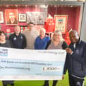 Gary Bennett hands over a cheque to Consultant Urological Surgeon and Clinical Director at Sunderland Royal Hospital, Stuart McCracken. Back from left, cancer nurse Jeanette Maughan, Fans Museum founder Michael Ganley, Mick Harford, Ron Hedley and Urology Directorate Manager Emma Scott.