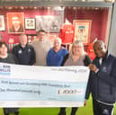 Gary Bennett hands over a cheque to Consultant Urological Surgeon and Clinical Director at Sunderland Royal Hospital, Stuart McCracken. Back from left, cancer nurse Jeanette Maughan, Fans Museum founder Michael Ganley, Mick Harford, Ron Hedley and Urology Directorate Manager Emma Scott.