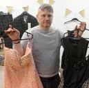 Lee Nicholson with some of the donated prom dresses and suits.