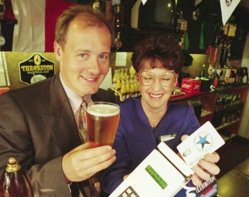 John Hedley prepares to savour the Ashbrooke's best lager by paying by card. Here he is with landlady Cathy Redpath.