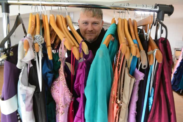 Lee Nicholson with some of the 100 donated prom dresses. 