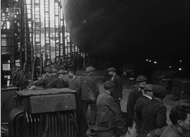 Workers wait for the launch ceremony to begin.