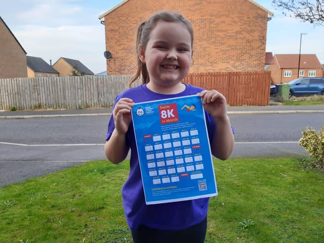 Olivia Turnbull with her 8km swimming challenge form.