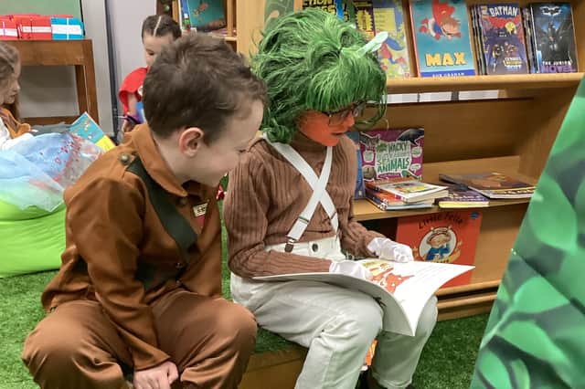 Children enjoying some paired reading.