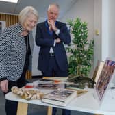 Kate Adie alongside Vice Chancellor Sir David Bell and some of the items chronicling her career.