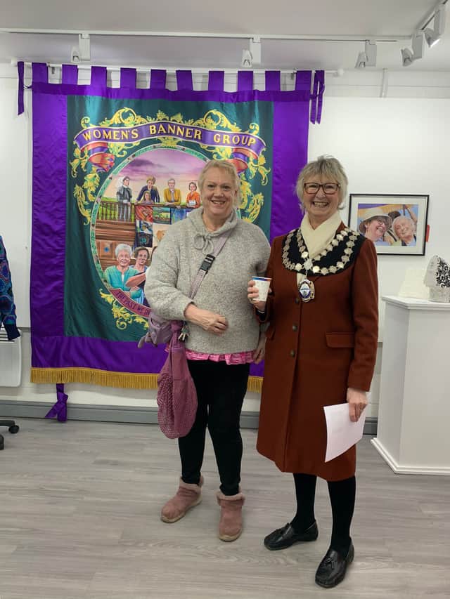 EDAN member Alison Lowery admires the exhibition with the help of the Mayor of Seaham, Jennifer Bell.