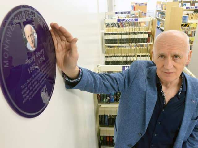 Terry Deary unveils his plaque in the school's library.