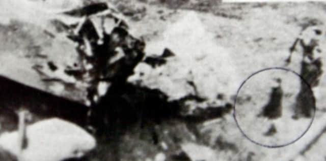 Alan Mitcheson, circled, surveying the site of the plane crash in 1944.