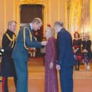 Gill and John Griffith receiving their MBEs from Prince William at Windsor Castle.