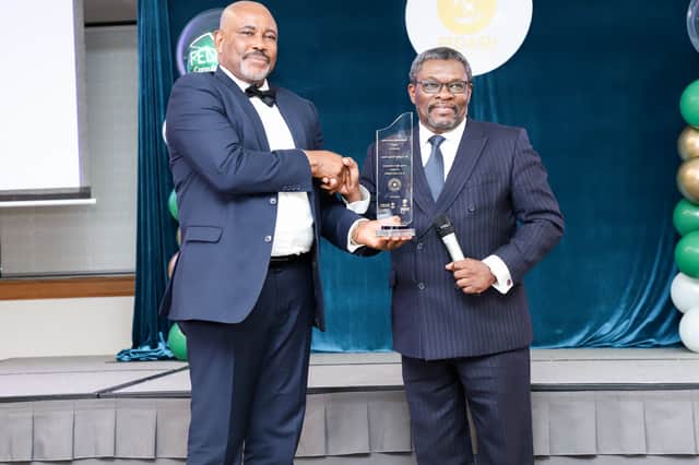 Acting Nigerian High Commissioner Dr. Cyprian Terseer Heen (left) receiving an award. 