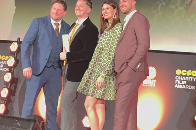 John and friends on stage with awards host Ellie Taylor.