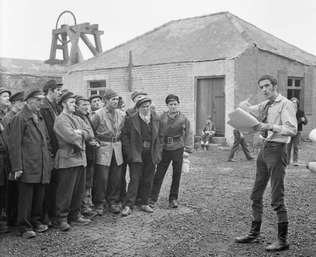Director John Davies instructs some of the local extras before filming starts.