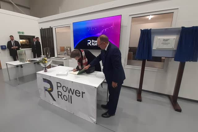 Princess Anne signing the visitors book alongside Power Roll CEO, Neil Spann.