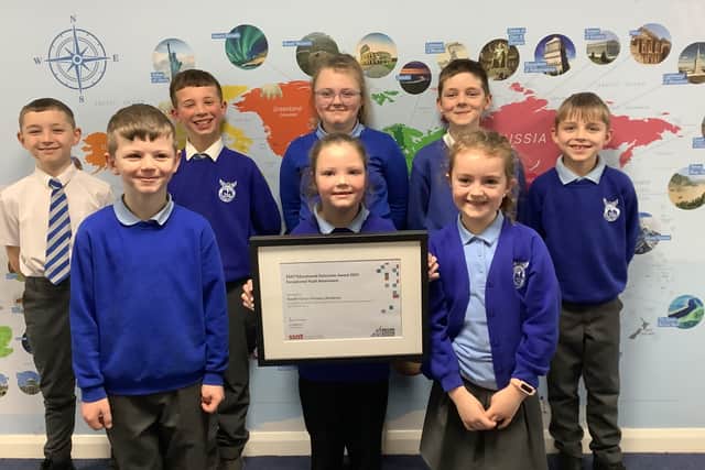 Children from South Hylton Primary Academy proudly display their SSAT Educational Outcomes award for being in the top 20% of schools nationally for pupil attainment.
