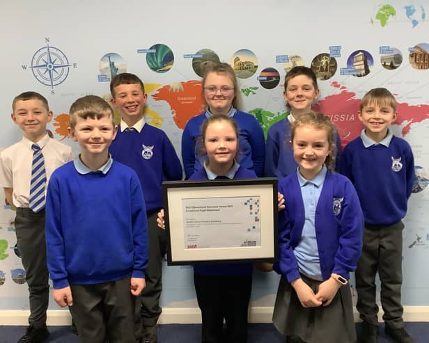 Children from South Hylton Primary Academy proudly display their SSAT Educational Outcomes award for being in the top 20% of schools nationally for pupil attainment.