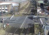 A car ignoring the signals and crossing the other side of the road to quickly dodge the closing barriers (Langley Green level crossing, West Midlands).  