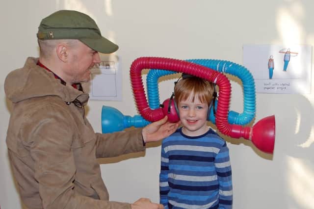 Artist and inventor Dominic Wilcox tries out one of his inventions during the Little Inventors project in 2016